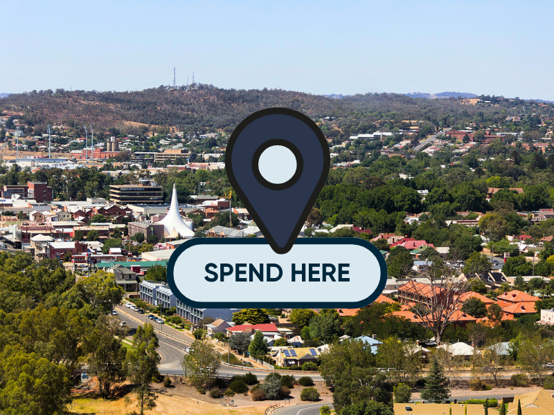 Wagga Wagga cityscape featuring a "Spend Here" graphic, promoting local businesses participating in the Wagga Wagga Gift Card program.